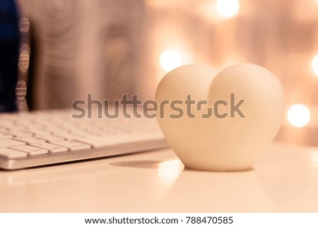 The luminous white heart with romantic bokeh background.