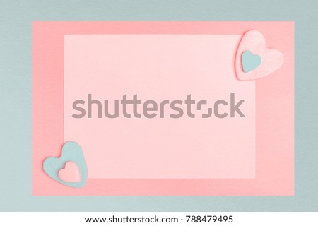 Frame on Valentine's Day and Love background or greeting card template, flat lay, space for a text,  hearts on soft pink and light blue pastel colored paper backdrop
