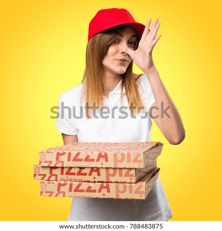 Pizza delivery woman making a joke on colorful background