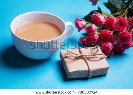 Coffee and roses , chocolate , gift boxes , paper heart on blue table . Valentine day background . Morning breakfast for Valentines day . holiday background . greeting card