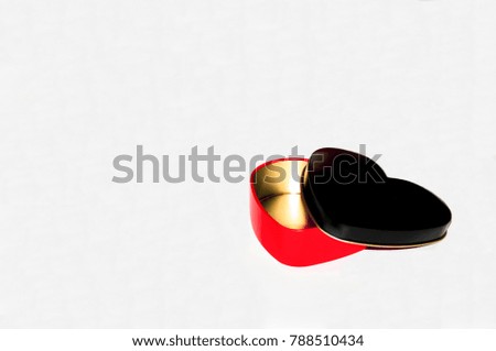 Metallic red, black, gold gift heart shaped box for Valentine's day on white background