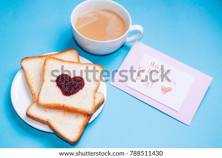 Toast with strawberry jam in a heart shape and coffee , pink roses , gift box .Valentine day background .Morning breakfast for Valentines day. holiday card