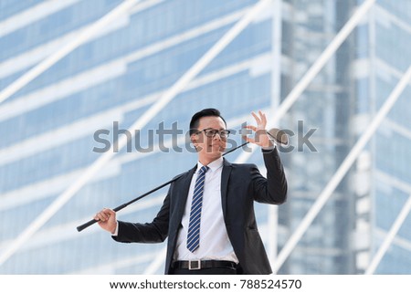 Successful businessman in suit. hand holding golf equipment standing the city. success concept in city background