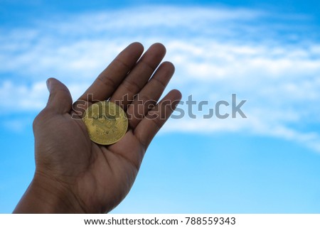 Bitcoin. Royalty high quality free stock image of bitcoin. Bitcoin in hand with blue sky background