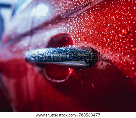 Details of electric car. Door handle and rain drops. Red color Royalty-Free Stock Photo #788563477