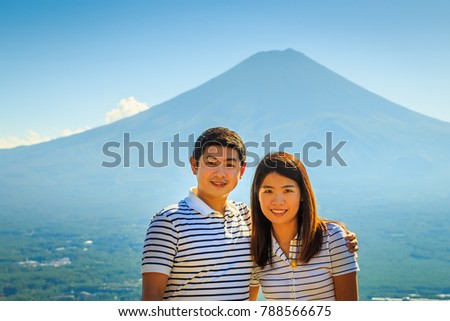 couple tourists outdoor portrait with famous Fuji volcano background