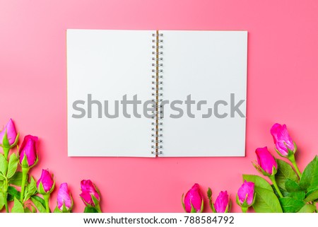 Pink roses decorative with blank notepad on top view flat lay for your text,for valentine and wedding sweet love concept vintage tone on pink background.