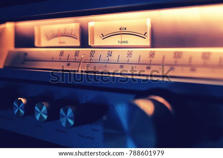 Retro radio tuner receiver with amplifier and FM tuner scale section and tone balance knobs in front panel Royalty-Free Stock Photo #788601979