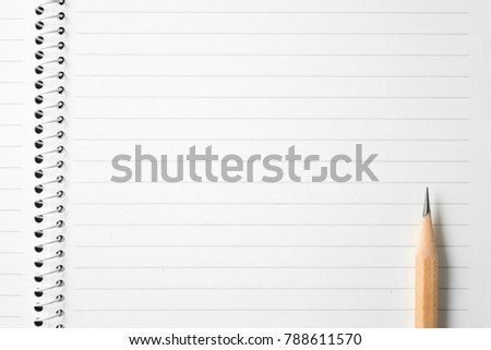 High resolution top view close up photo of wooden pencil put on opened spiral binder lined notebook with copy space.Flash light made smooth shadow from wooden pencil and clean look of lined paper. Royalty-Free Stock Photo #788611570
