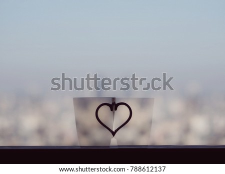 Blurred background with two cups. It means, you are falling in love and found your better half.