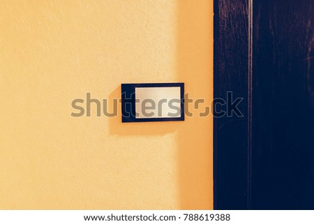 The door of a room in an expensive hotel. Without number. 