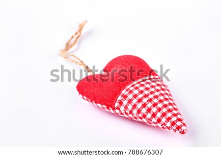Handmade textile heart with string. Red and checkered fabric heart isolated on white background. Shop cute gift on Valentine day.