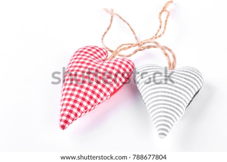 Two handmade fabric hearts. Colorful textile hearts isolated on white background.