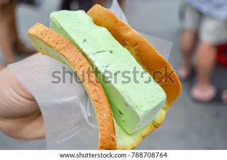 Hand Holding a Singaporean Ice Cream Sandwich Royalty-Free Stock Photo #788708764