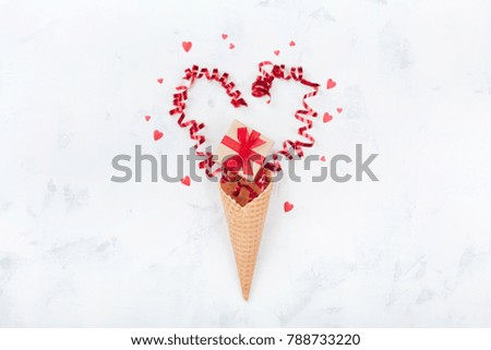 Valentines day creative composition with waffle cone, gift or present box and hearts on white background top view. Fashion flat lay.