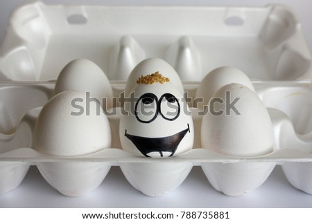 conception of hair. treatment of the bald patch. the eggs are funny and cute. photo with painted face on the shell. satire and comedy. The egg is a scapegoat on the head
