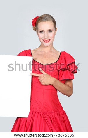 Woman dressed as a flamenco dancer pointing to a blank rectangle