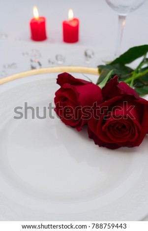 Valentines Day Dinner - plate with flowers and burning candles