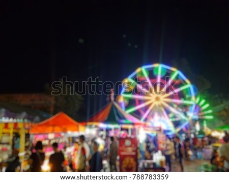 Temple fair colorful flag night party, Thai temple festival fair in blurred and de-focus Royalty-Free Stock Photo #788783359
