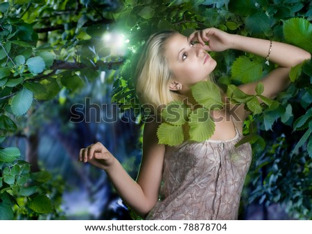 Beautiful romantic woman at misty forest