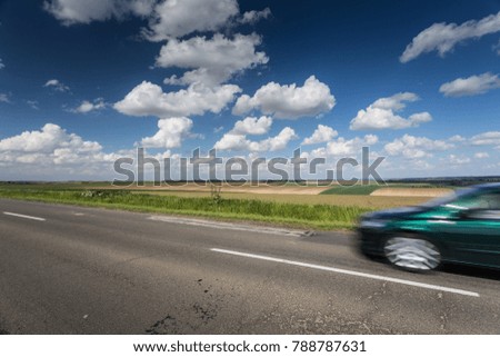 fast moving car with cloud sky