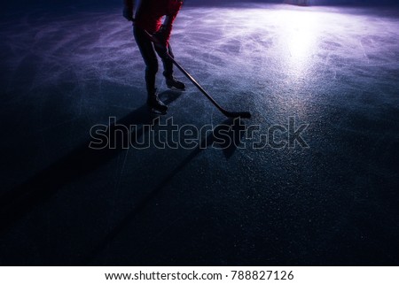 Hockey concept photo - hockey stick on ice in dark