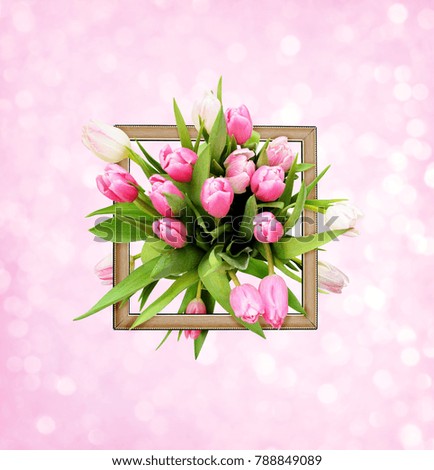 Pink tulip flowers bouquet and a frame on bokeh background. Top view.