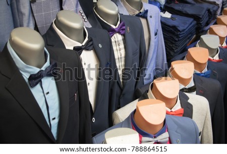 Beautiful men's blue jacket suit with shirt and pink tie on a mannequin isolated on white background