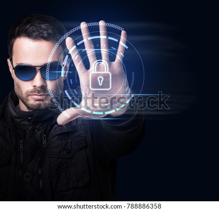 Man in sunglasses controls virtual system by hand.