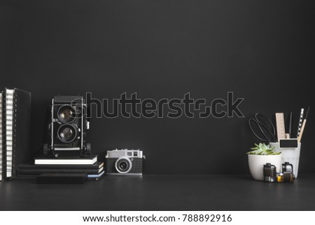 Photographer or artist workspace on black background.