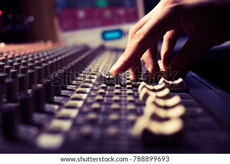male sound engineer hands working on sound mixer for recording, broadcasting, music production background Royalty-Free Stock Photo #788899693