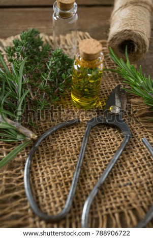 olive oil with herbs on wooden surface