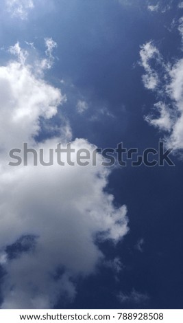 Background of fluffy white clouds on beautiful blue sky.