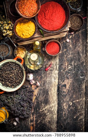 Various spicy spices and herbs. On a wooden background.