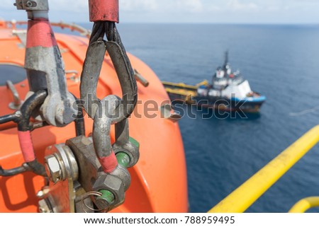 Close up shackle at lifeboat with blur supply boat Royalty-Free Stock Photo #788959495