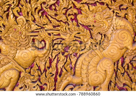Carved lion Thai style art on door of the temple