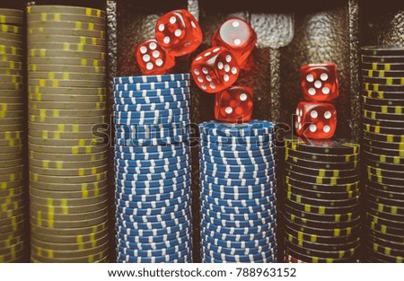 Casino / poker chips colorful gaming pieces lie on the game table in the stack. Background for gambling / casino, business, poker. many colorful casino chips. vintage photo processing. Soft focus