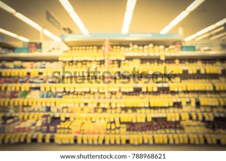 Blurred inside drug store in America with variation of pharmaceutical and medical supplies product. Blurry medicines on pharmacy shelves display with price tags. Vintage tone.