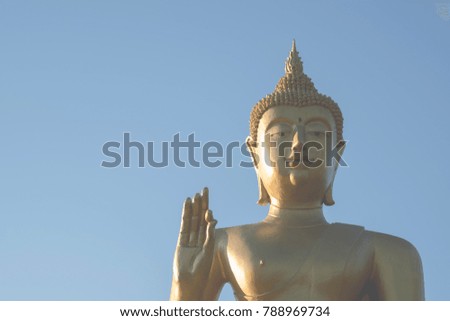 Buddha statue on blue sky background.