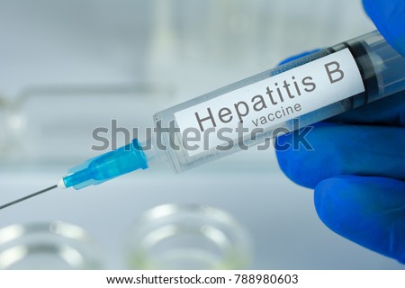 Vaccination healthcare concept. Hands of doctor or nurse in medical gloves with medical syringe ready for injection a shot of Hepatitis B vaccine. close up, selective focus Royalty-Free Stock Photo #788980603