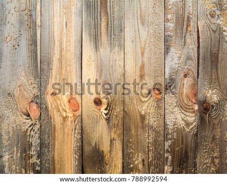 Summer or spring, winter day. Large construction site. In the frame is a fragment of a fence made of pine boards. Photo taken in Ukraine, Kiev. Horizontal frame. Color image