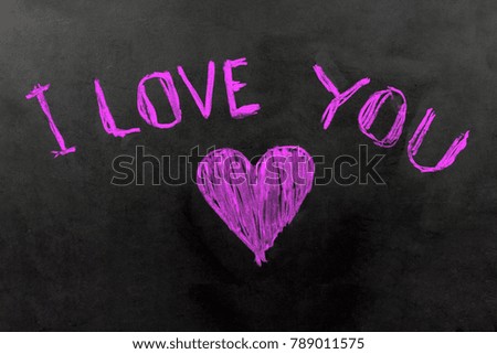 Purple 'I LOVE YOU' greeting message with Heart symbol on blackboard. Valentine's Day background