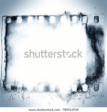 Blue grunge film strip frame on dripping background.