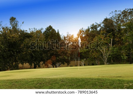 Background evening golf course has sunlight shining down at golf course in Thailand