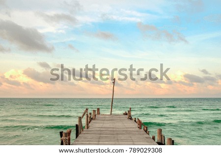 An Empty pier at daybreak stretching into the open ocean. Koh Rong, Cambodia. Royalty-Free Stock Photo #789029308