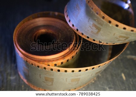 Old yellowed filmstrip curled with age