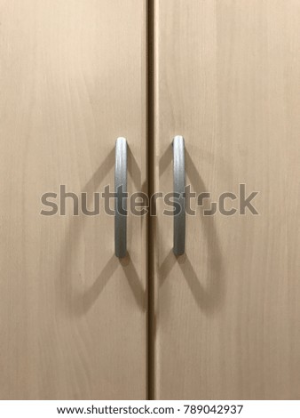 Gray handles of wooden wardrobe
