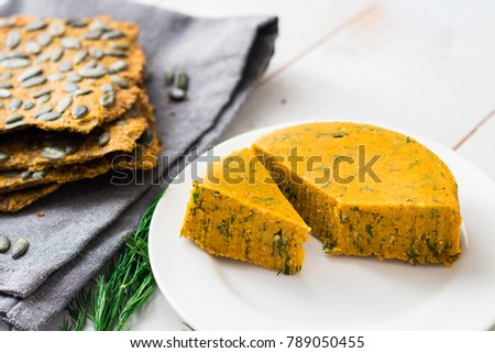 Raw vegan cheese with cashew, almond, carrot, pumpkin and herbs. With healthy flax and pumpkin seeds bread. Healthy food concept. Royalty-Free Stock Photo #789050455