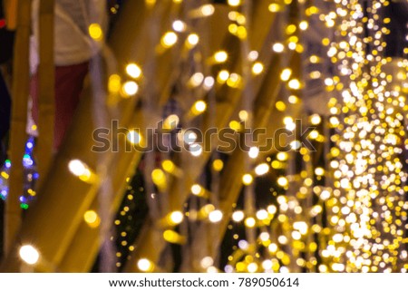 Bokeh background of de focused glittering lights. 
Colorful white and gold Christmas background pattern concept.