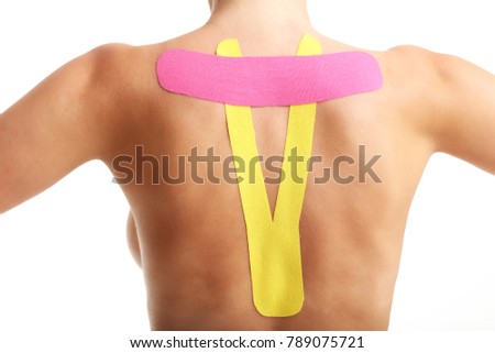 A picture of special physio tape put on injured back over white background